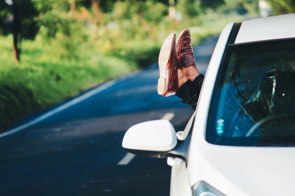 Person showing his feet outside the car window